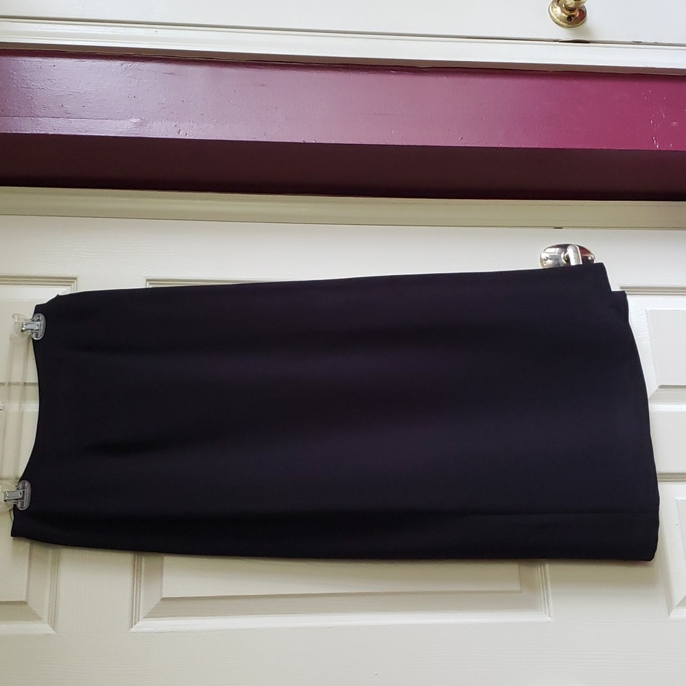 Wrap around black long skirt, fully lined, dry clean only.with a silver buckle .